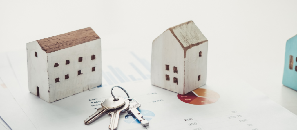 Two white wooden house models